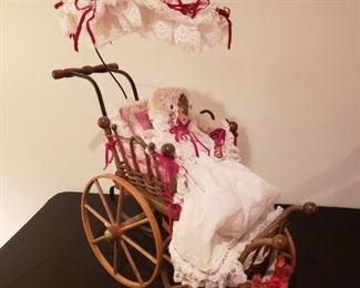 Collector doll in antique buggy