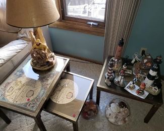 World map nesting tables; light house figurines, sailor lamp.
