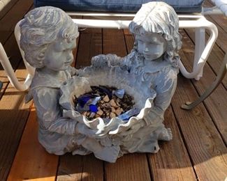 Outdoor planter statue of boy and girl