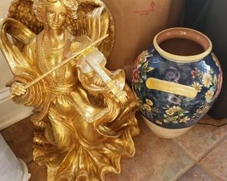 Gold angel playing violin, vase
