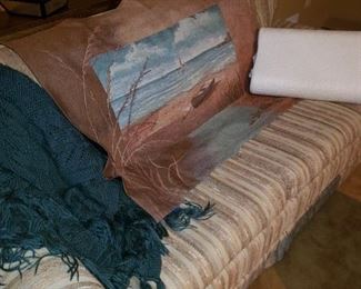 Sleeper sofa, blankets, tapestry