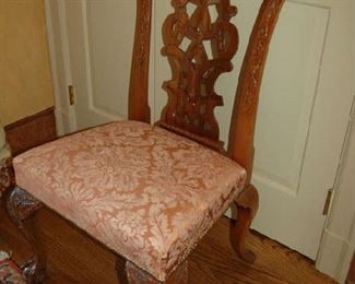 One of 12 Chippendale-style dining chairs