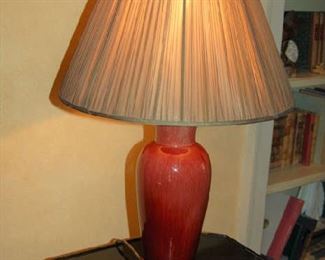 One of pair of sang de boeuf lamps with custom shade