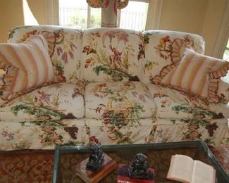 Three-place sofa with custom fabric and silk pillows