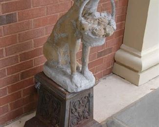 Concrete dog on pedestal