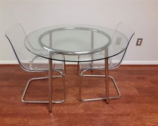 Round glass top and Chrome dining table with lucite and Chrome chairs