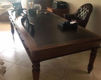 Very large leather topped desk  A Large Mahogany Partner's Desk,  inset tooled leather top, frieze with four paneled drawers on each side, turned  tapered legs $1500, leather tufted desk chair $275
