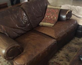 Leather loveseat with a damage $100