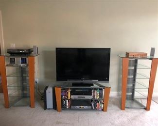 Entertainment center — two wood and glass three-tiered bookcases and glass and wood TV stand