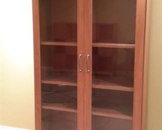Two very pretty identical glass door cabinets that have matching two drawer cabinet with cubby hutch.
