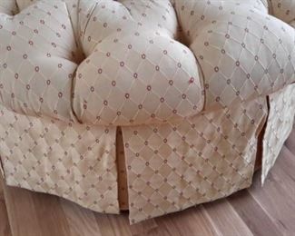 Cute tufted ottoman on casters.