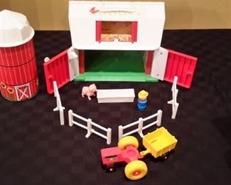 1968 Fisher-Price Little People Farm. Has farmer, pig, trough, fence, tractor and trailer, and silo. Door still "MOO'S" when opened!