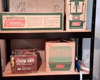 Vintage Coleman camping items in original boxes and camping cook set.