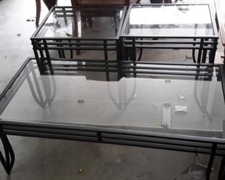 Pretty coffee table and two end tables with glass tops and black metal bases.