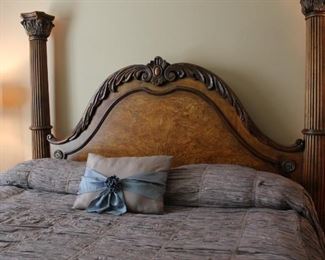 king sized bed carved wood with pillar style bed posts. 