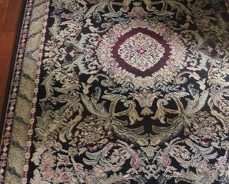 2 sizes: Classic rug in beautiful color palette of greens and berry colors along with cream and black background.