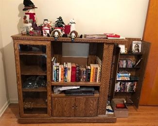 Entertainment center; numerous books, DVDs, CDs.