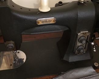 Vintage White sewing machine in cabinet