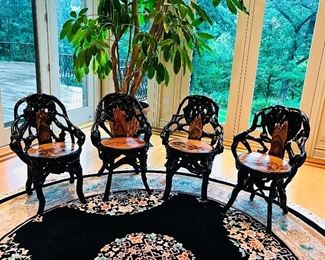 A SET OF 4 BLACK TREE ROOT WOODEN CHAIRS WITH HAND-PAINTED SEAT: An exquisite set of four black chairs crafted from roots of a tree wood with a hand-painted seat. Height from floor to top of back 34 x Width 23 x Seat Height 18 inches. 