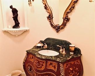 A French style commode, marble top with sink and gold finished hardware.