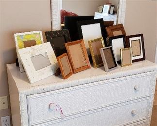 white wicker chest, mirror, picture frames