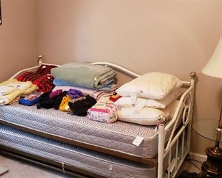 trundle bed and mattresses, blankets, pillows, lamps