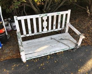 white wooden porch swing