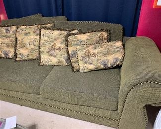 Large green sofa. Animal print reversible on the smaller pillows
