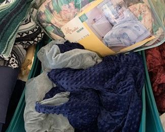 Bin of blankets and bed spreads
