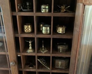 Brass collection in display cabinet