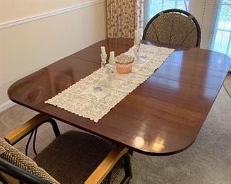 1950s Dining table with 4 leaves and pads. Two modern chairs sold separately.