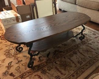 Wood and wrought iron coffee table; area rug