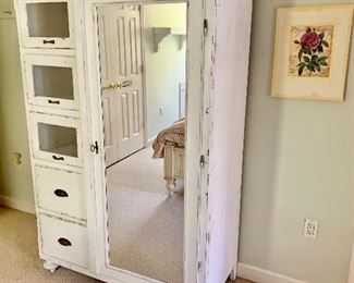 Shabby chic armoire with drawers and mirrored door.