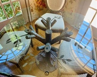 Beveled glass top table with metal tree limb base