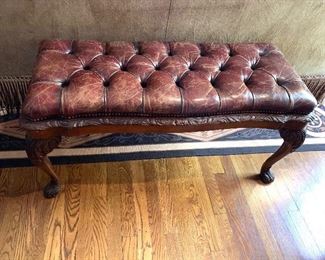 Antique distressed leather bench with carved legs