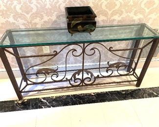 Ornate metal console table with glass top
