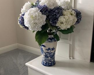 Blue & white decorative vase with silk flowers.