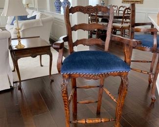 Set of three ladder back counter-height stools, upholstered in blue fabric with braided trim.