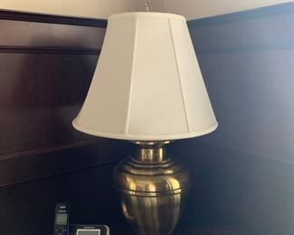 Bulbous brass table lamp, cream shade with finial.