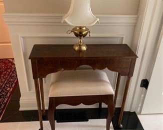 Mahogany table with stool upholstered in cream silk fabric.
