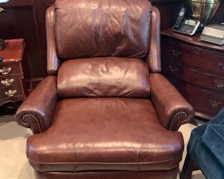 Leather overstuffed recliner, rolled arms, nailhead trim.