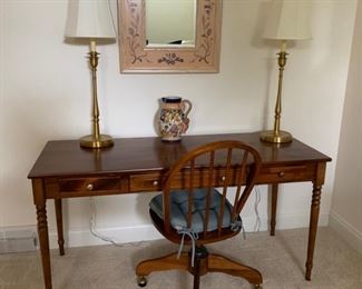 Desk, three drawer. Pair of brass table lamps, office chair on casters.