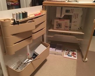 Sewing machine cabinet with accessories