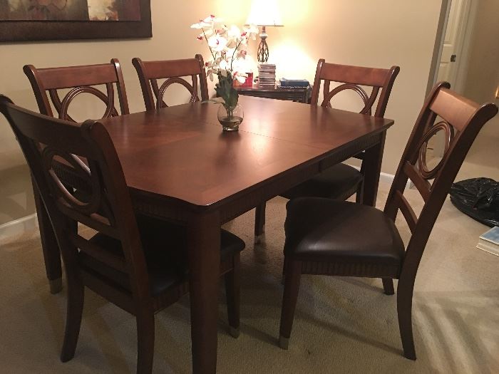 Outstanding dining room table with 6 chairs and an extension with custom made protection pads