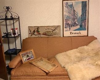 Metal and glass shelves, large overstuffed sofa. Fur rug or throw, electric heater and lots of picture!