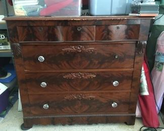 Burled wood chest with glass knobs.