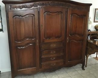 Circa- pre- 1920’s armoire with four drawers and adjustable shelf in upper center cabinet. Hanging space in both outer doors.