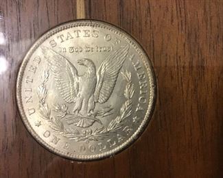 Back of bottom (6-o’clock ) silver dollar.