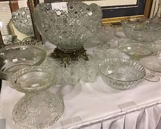 Crystal punch bowl with 12 cups, various cut glass and pressed glass bowls and raised plates.