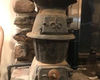 wonderful old iron cook stove with flour de lis